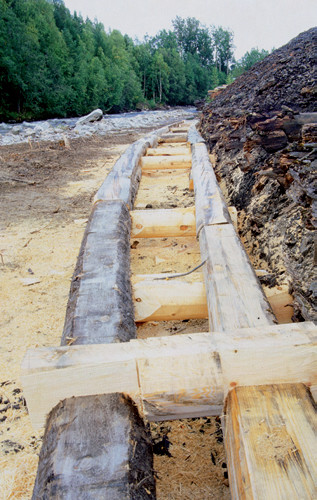 Restaurering av anleggets tømmerkisteforbygning